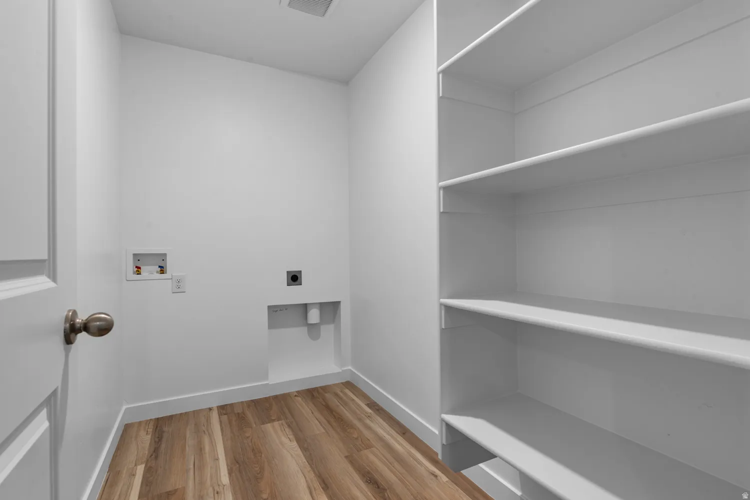Laundry room with light wood-type flooring, washer hookup, and electric dryer hookup