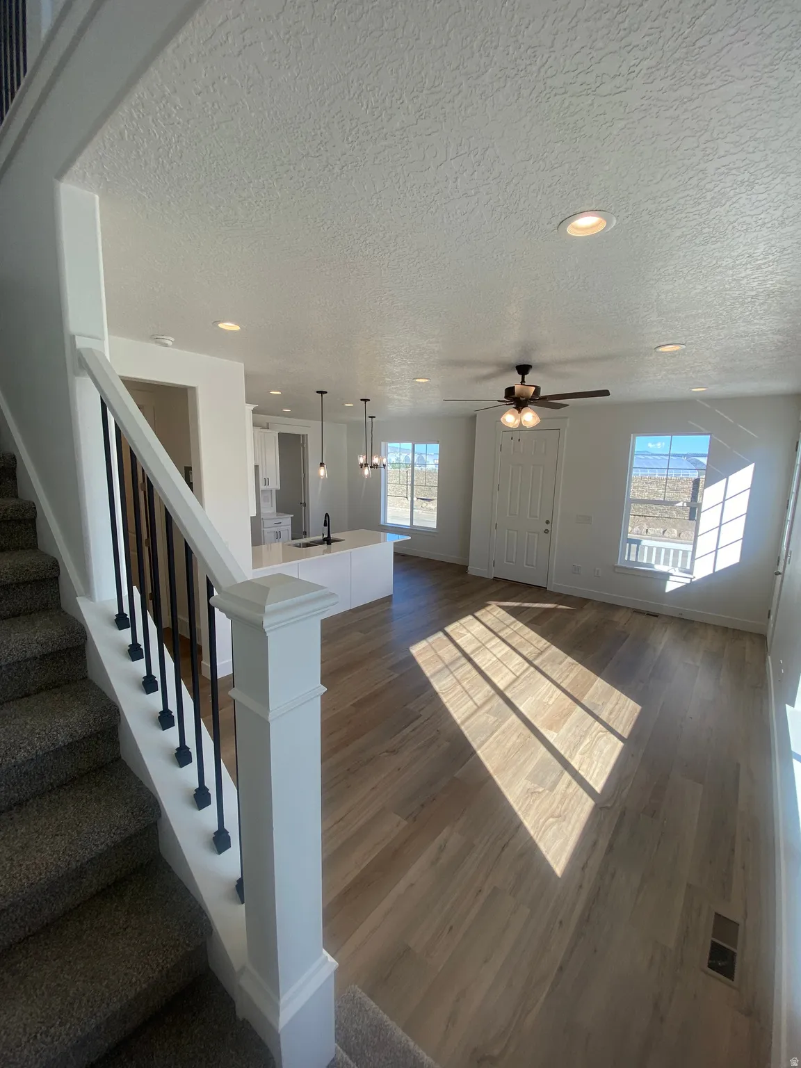 Foyer with recessed lighting, dark wood-style floors, a textured ceiling, and a ceiling fan*Photos are for reference only and are not of specific unit listed.  Finishes may differ from pictures shown.