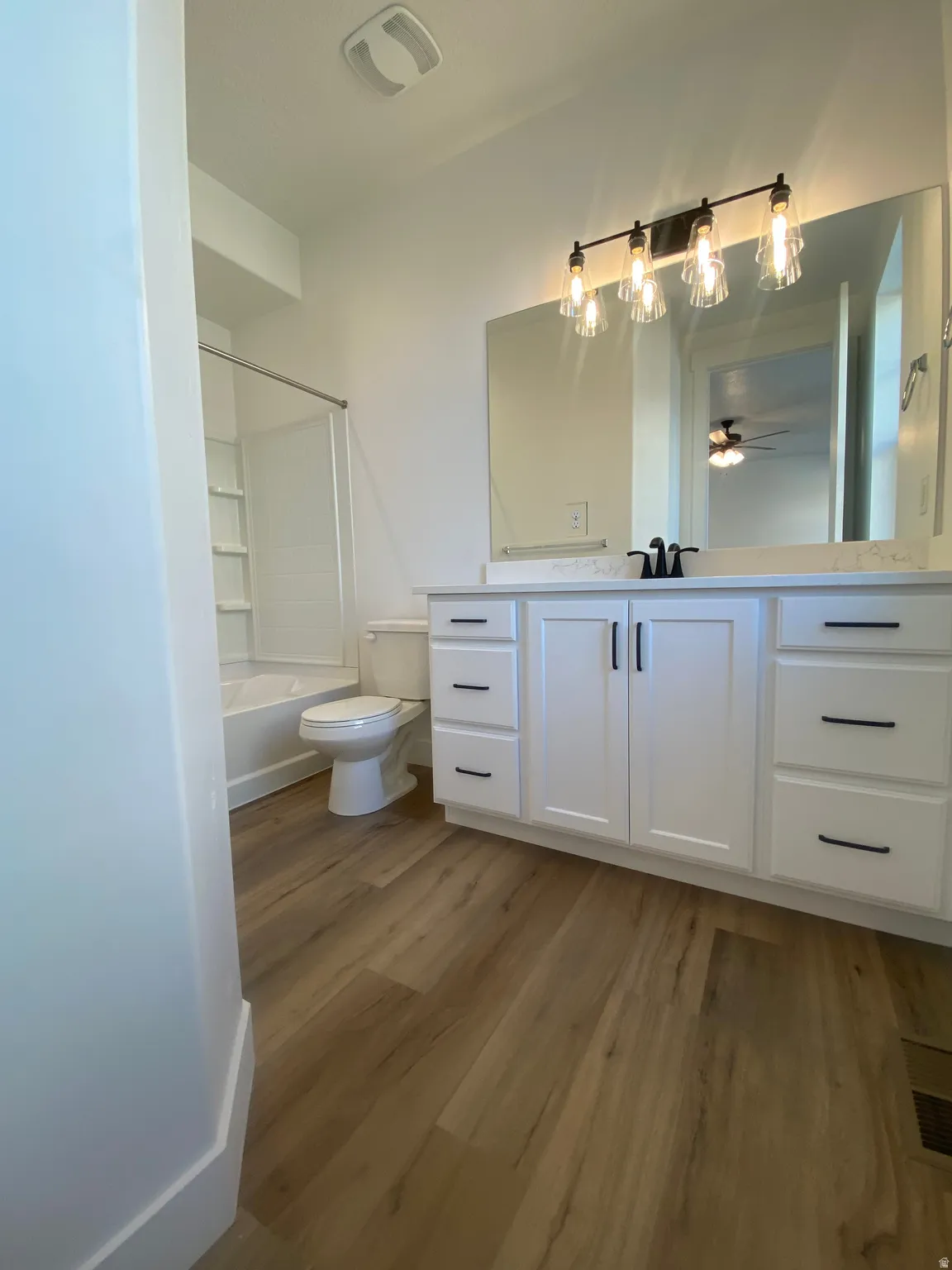 Full bath featuring vanity, dark wood finished floors, and bathtub / shower combination*Photos are for reference only and are not of specific unit listed.  Finishes may differ from pictures shown.