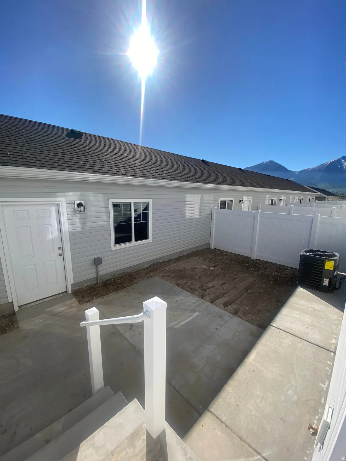 Rear view of property featuring a patio area, roof with shingles, and a mountain view*Photos are for reference only and are not of specific unit listed.  Finishes may differ from pictures shown.