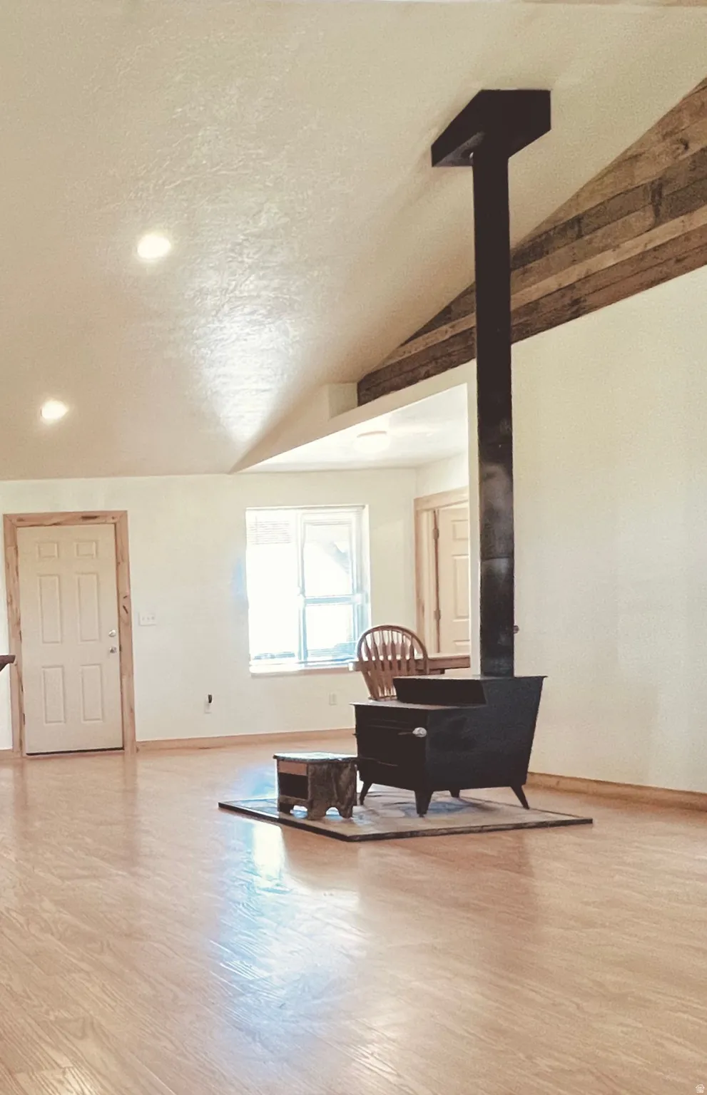 Living area featuring a wood stove and light wood-style floors