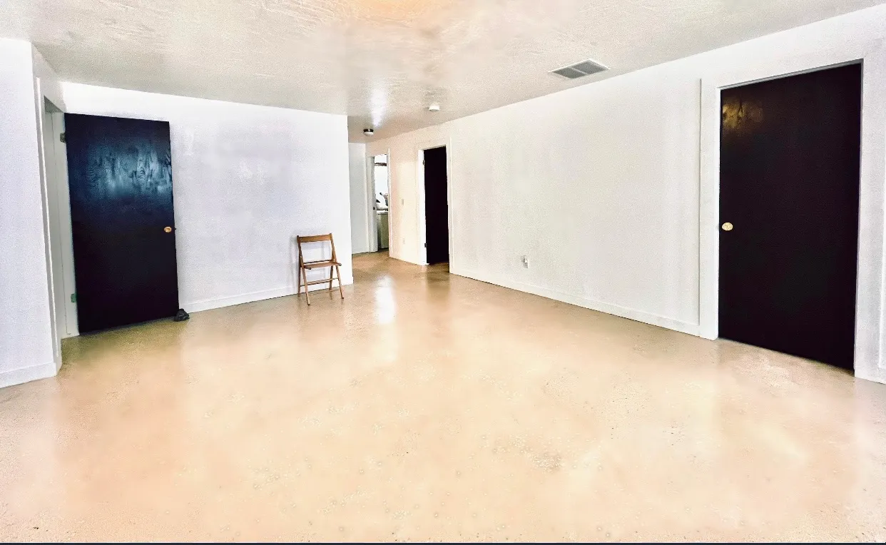 Spare room featuring concrete floors and baseboards