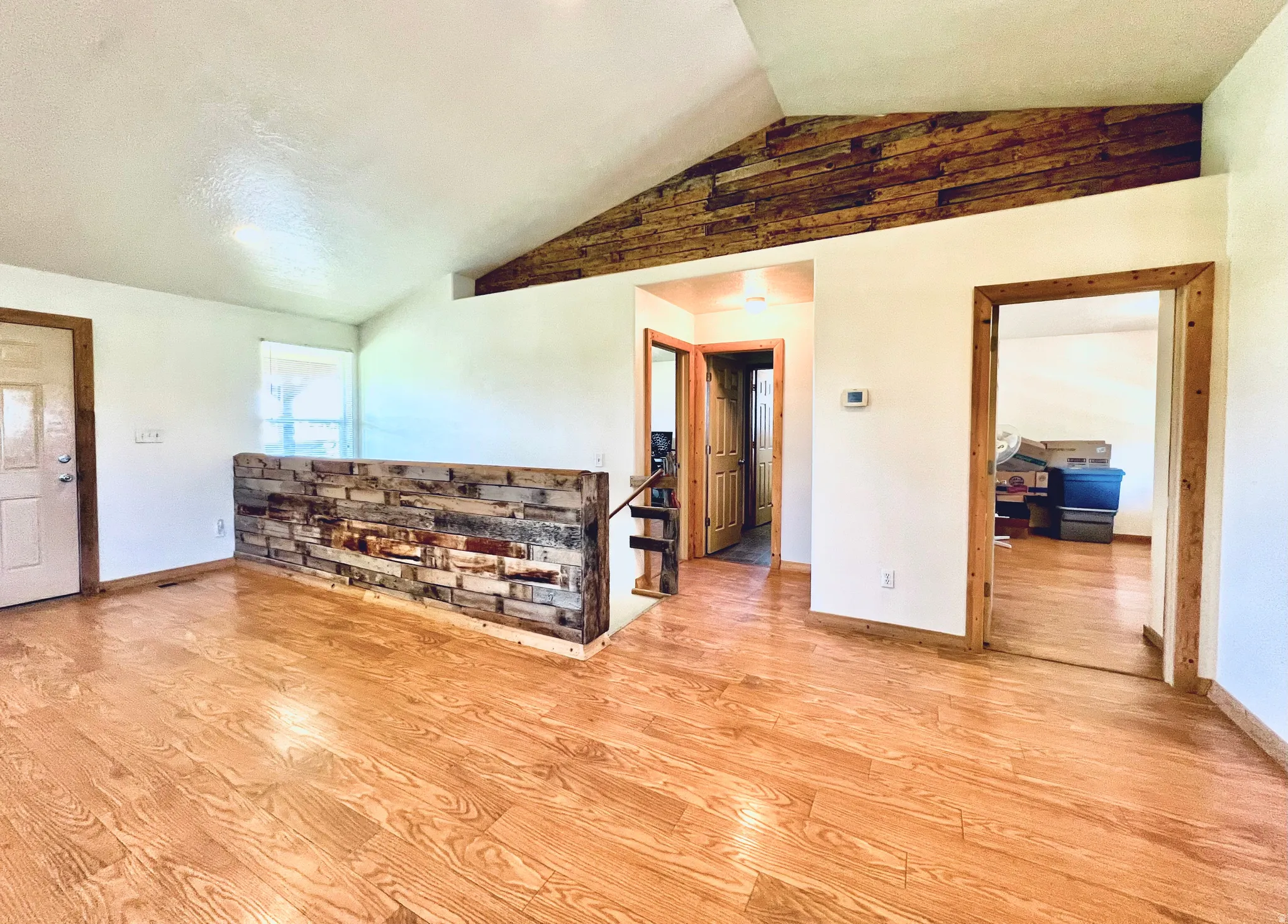 Unfurnished room with wood finished floors and baseboards