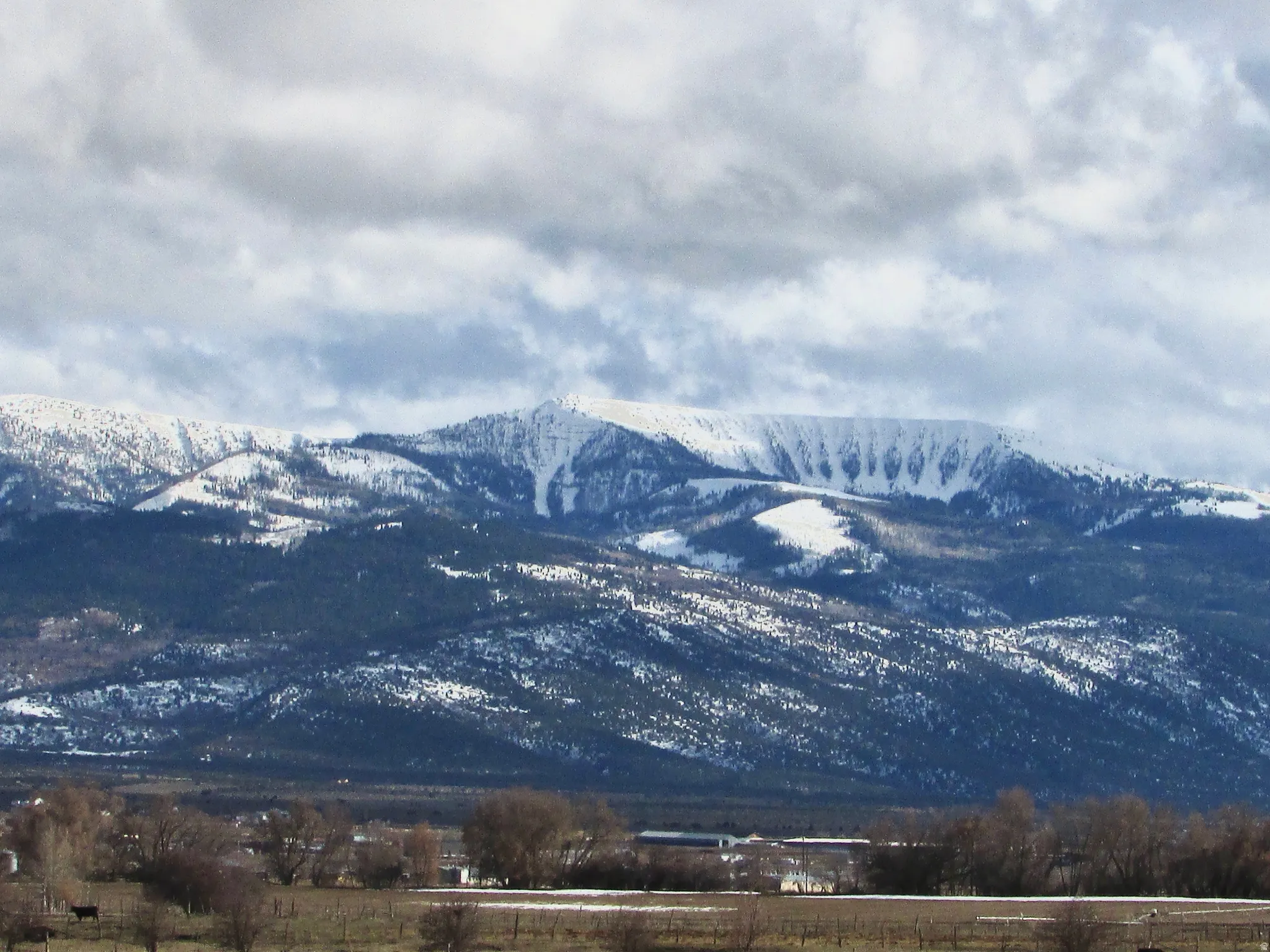 View of mountain background featuring rural landscape
