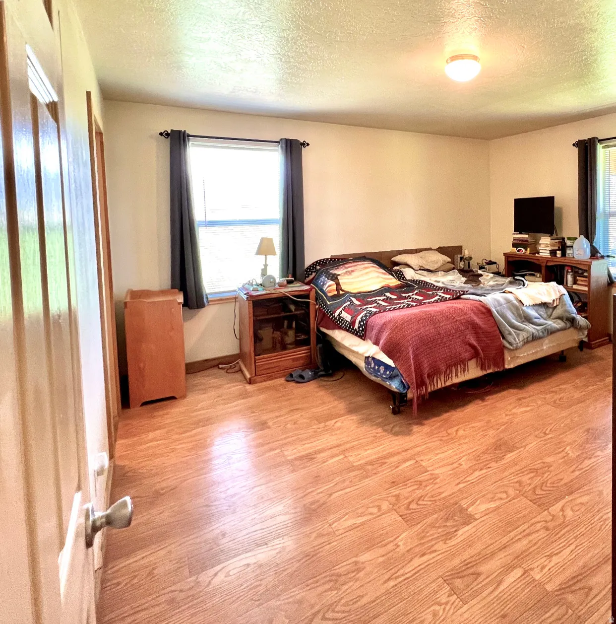Bedroom featuring light wood-style floors and a textured ceiling