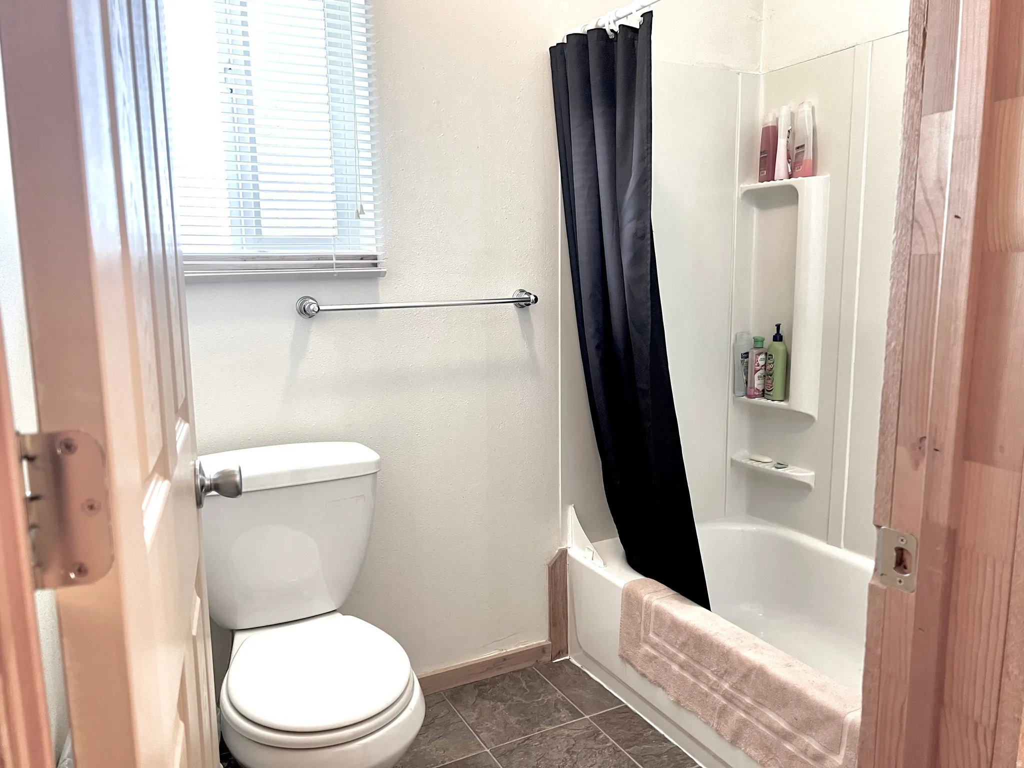 Full bathroom featuring toilet and shower / tub combo
