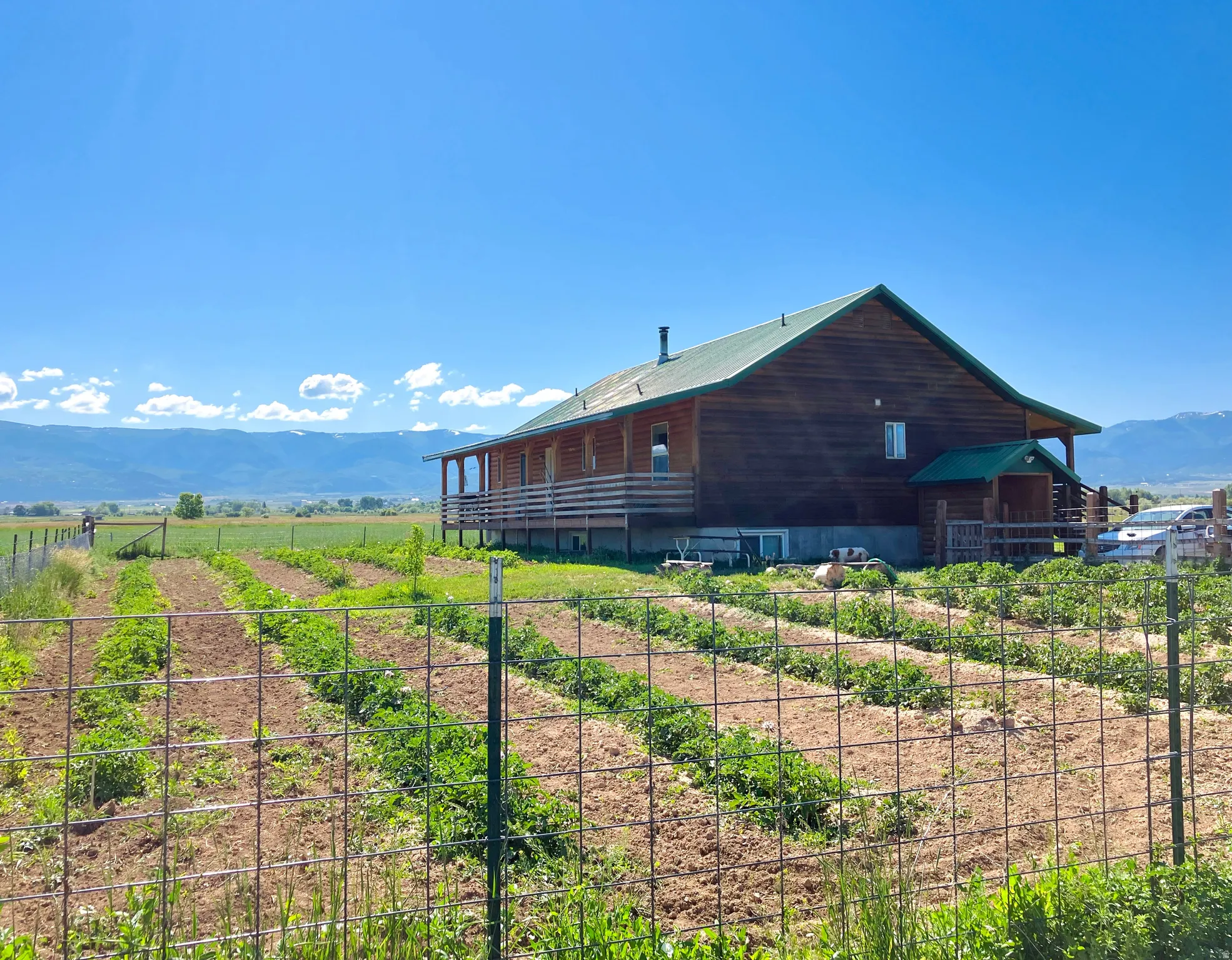 View of home's exterior with a mountain view, a rural view, and a metal roof