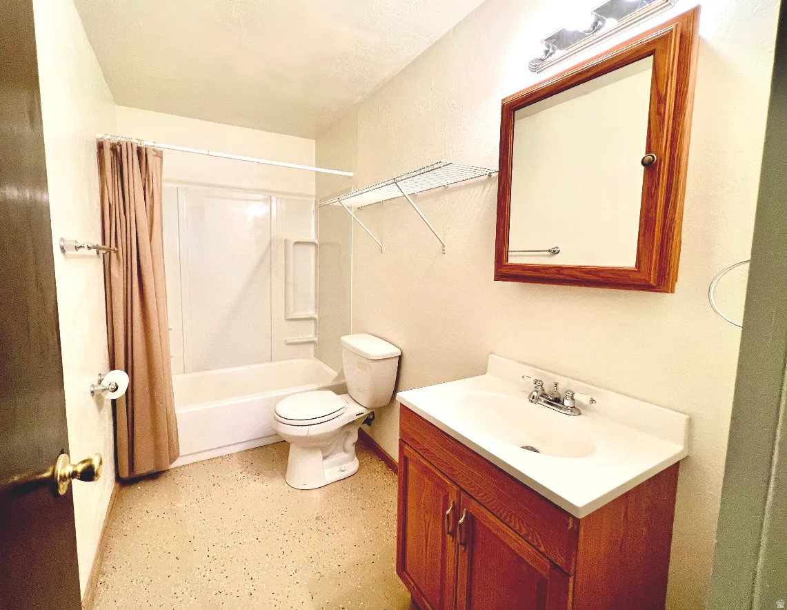 Bathroom featuring vanity and shower / tub combo