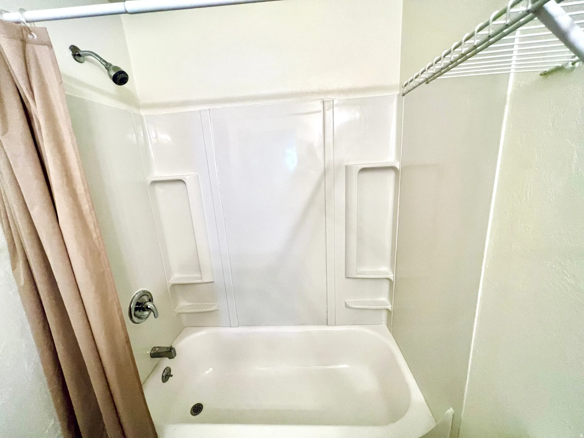 Full bathroom with shower / bath combination with curtain