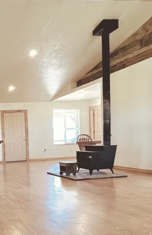 Living area featuring a wood stove and light wood-style floors