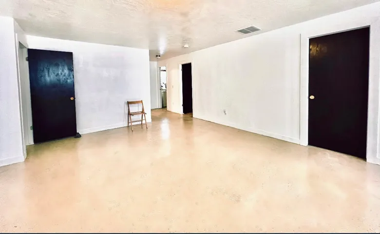 Spare room featuring concrete floors and baseboards