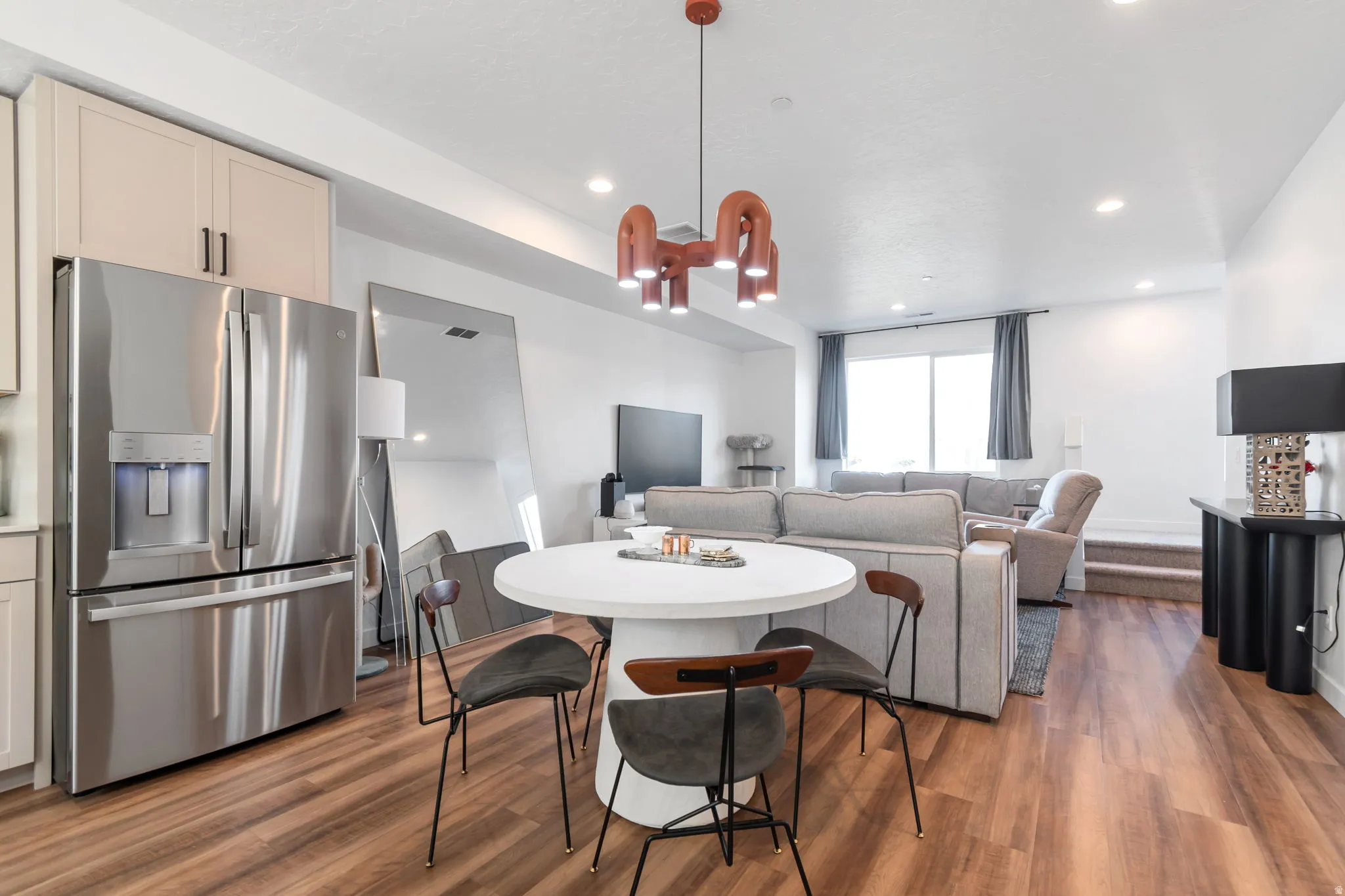 Dining area with dark wood-type flooring and recessed lighting