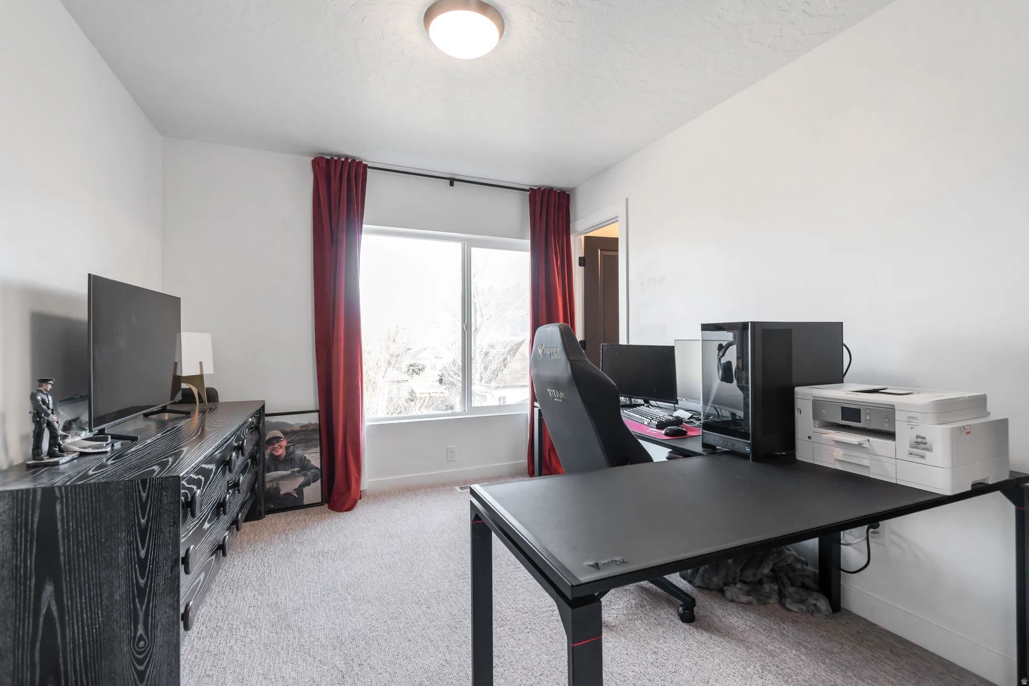 Home office featuring light carpet and baseboards