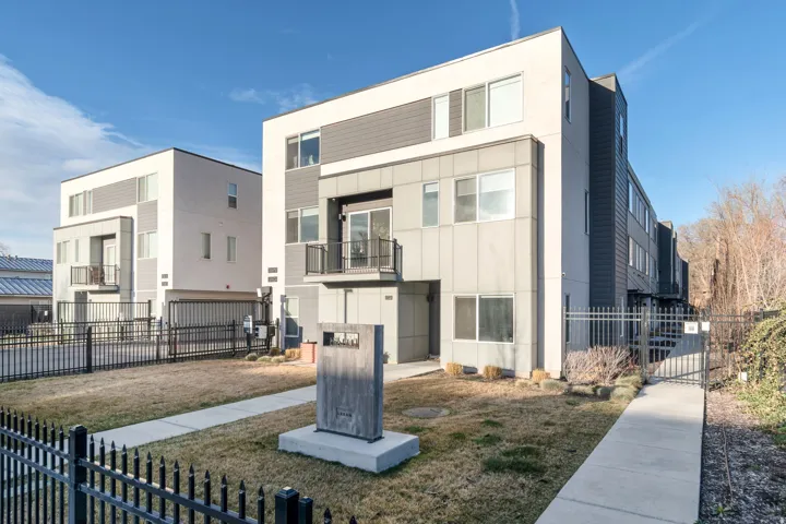 View of front of home with a balcony and a gate