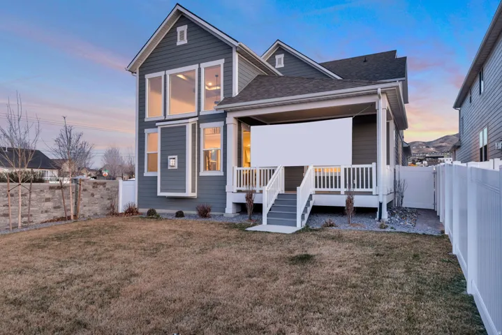 Back of property featuring a fenced backyard and roof with shingles