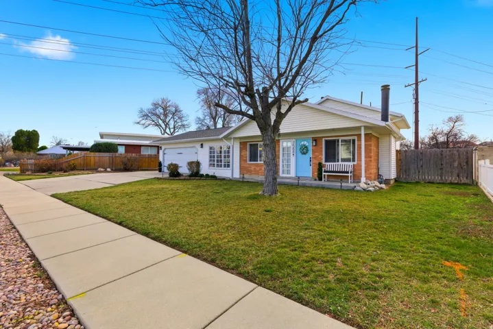View of front of house featuring concrete driveway, an attached garage, and brick siding
