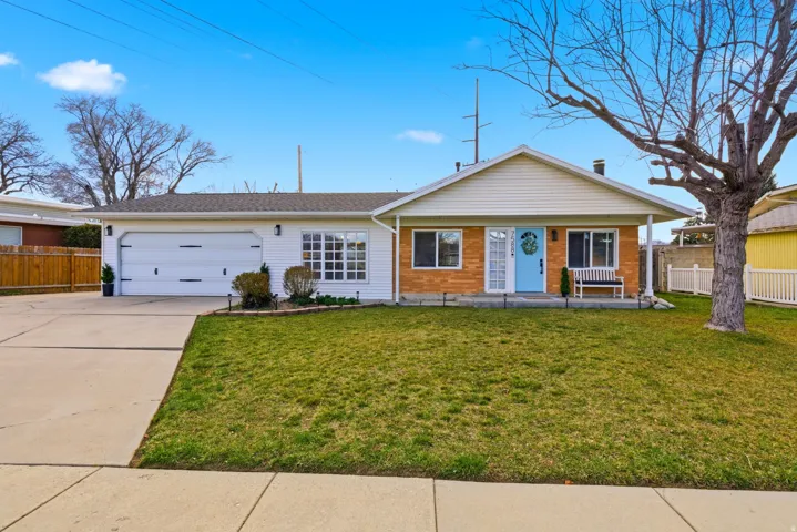 View of front of property with driveway, an attached garage, and brick siding