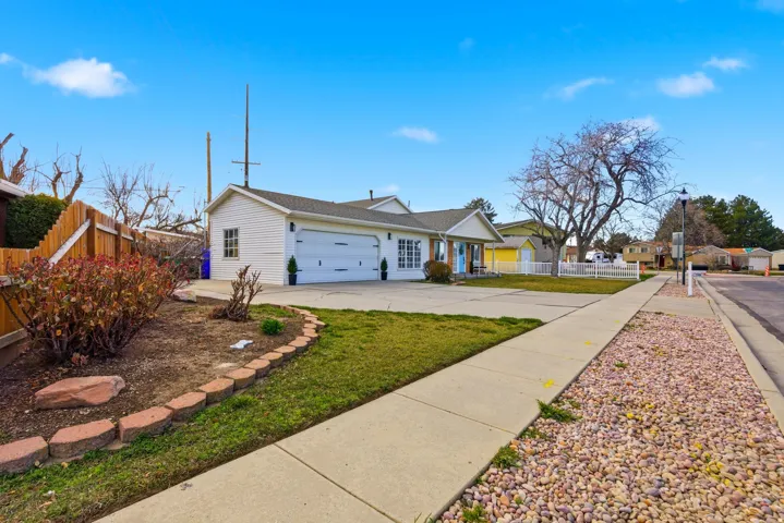 Single story home with concrete driveway and an attached garage