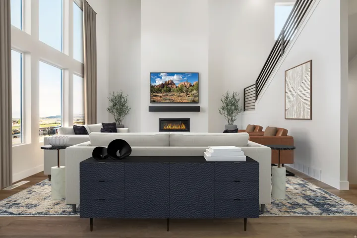Two-story living area featuring a fireplace with mantle, wood-finish flooring, abundant natural light from large windows, and a staircase with metal railing