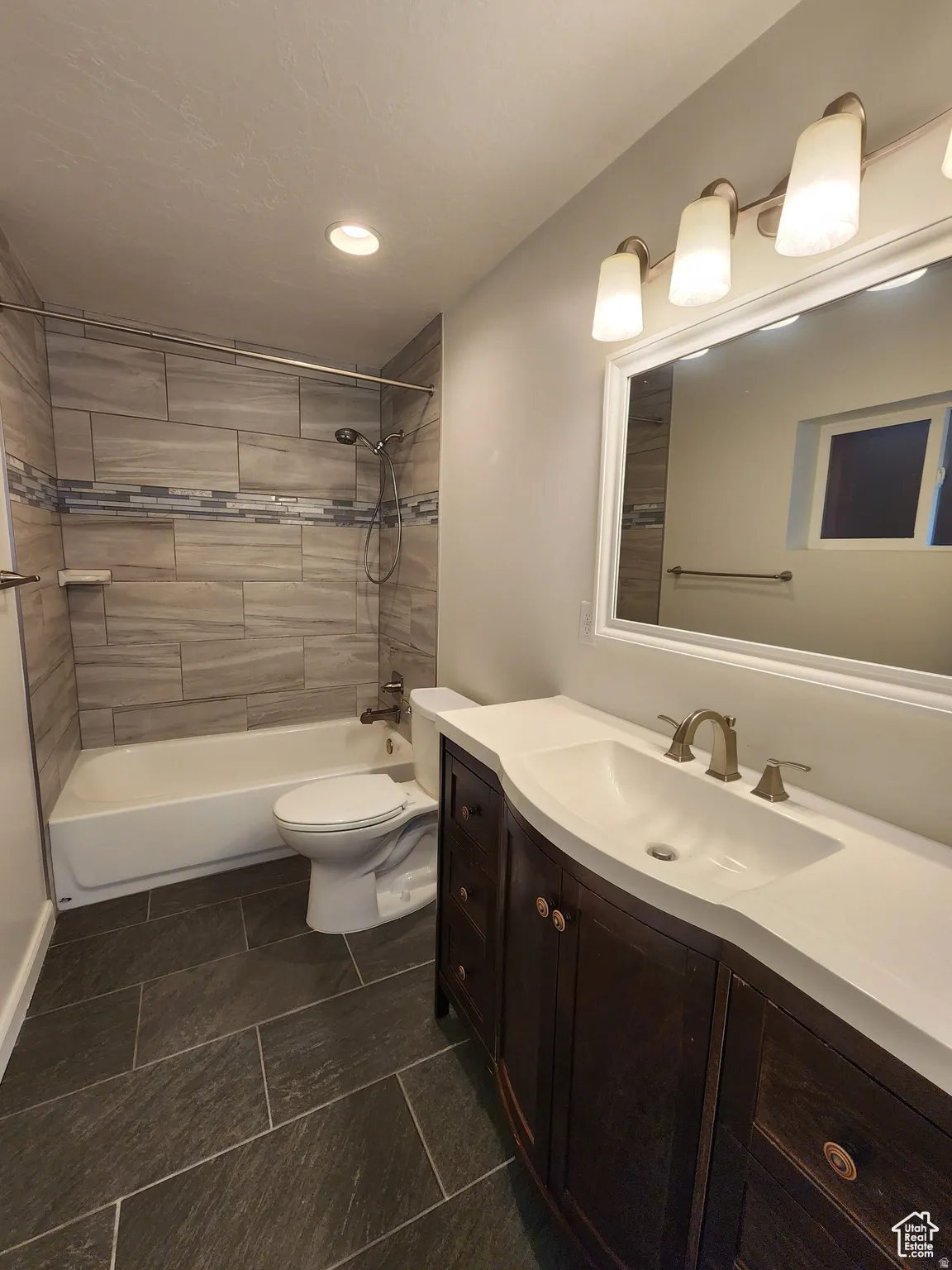 #1 Primary suite Private Bathroom featuring vanity, tub / shower combination, and recessed lighting