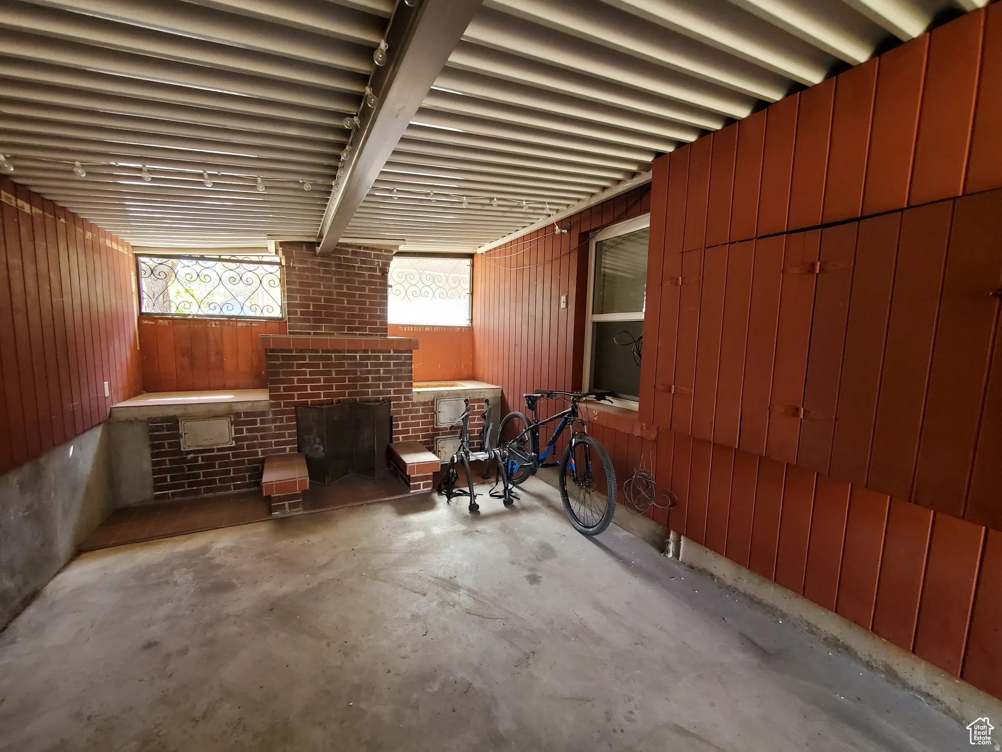 Community Common Area - Exterior Rear - with concrete floors, and a brick fireplace, open breeze