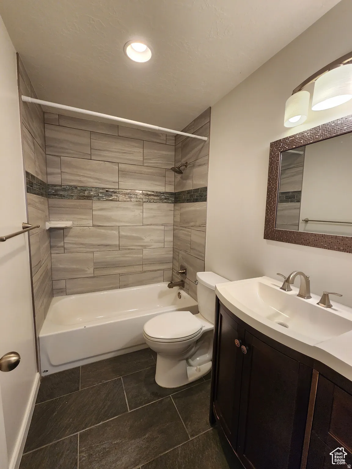 #1 Main bathroom featuring vanity and shower / tub combination