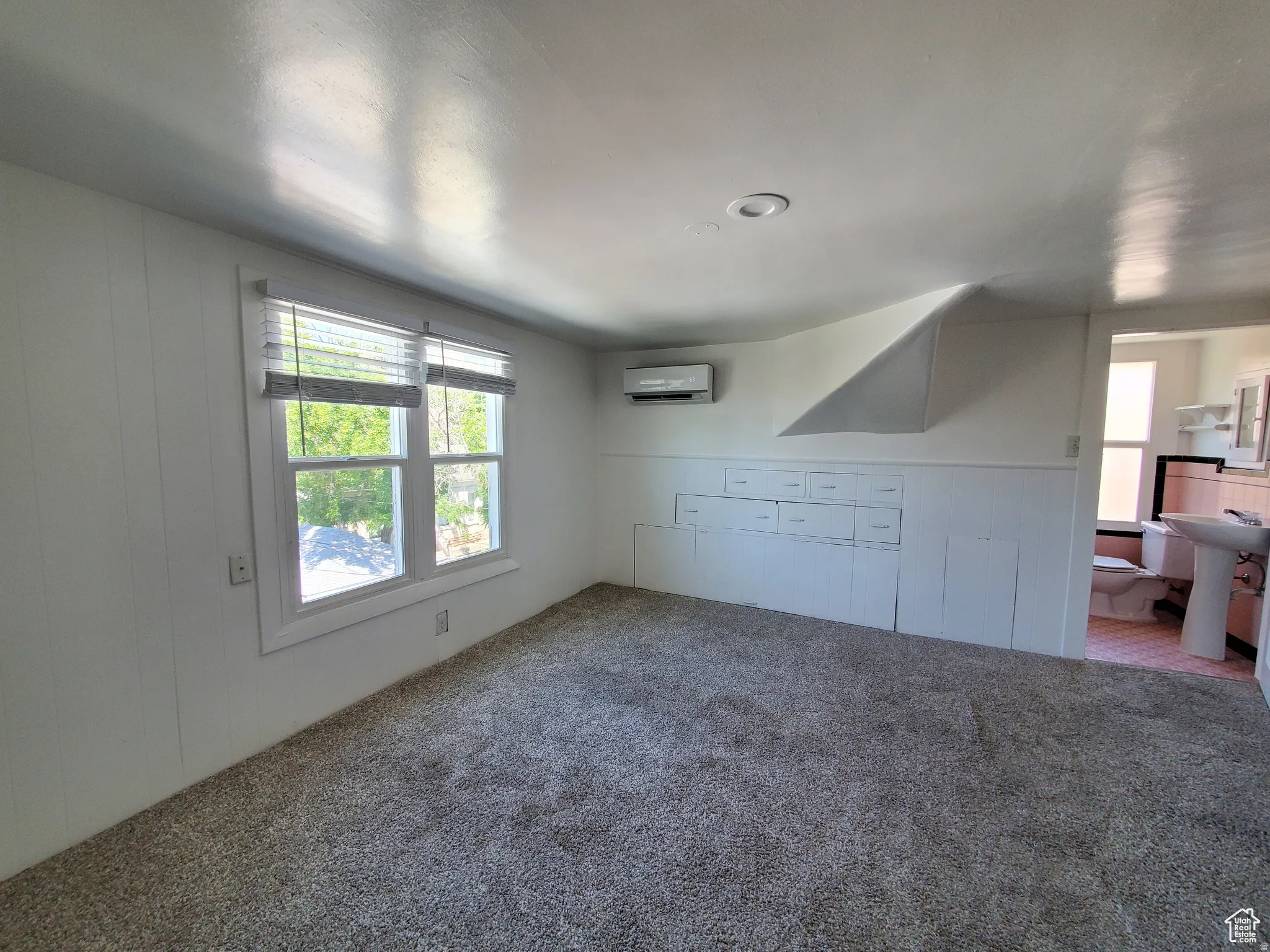 Studio unit featuring custom built-ins, lots of light, and a and mini-split A/C & Heat unit