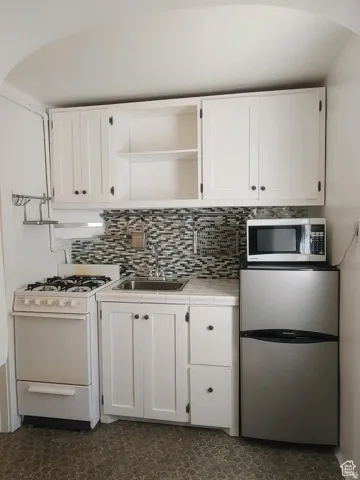 #7 & #8 Kitchens look similar, with open shelves, stainless steel appliances, white cabinets, and backsplash