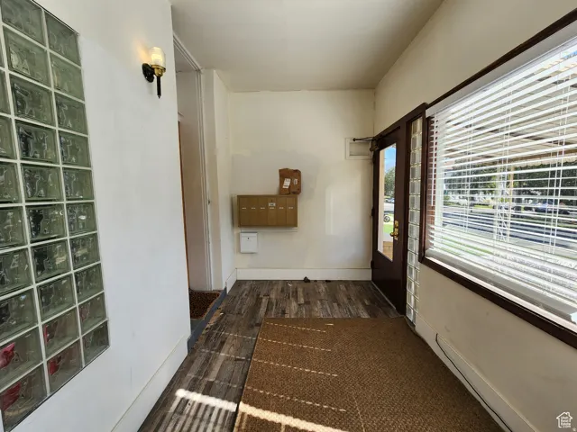 Community Entrance with dark wood, glass brick, mailboxes