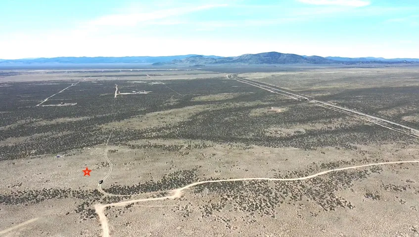 Aerial view of sparsely populated area featuring a mountainous background