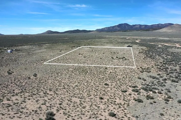 Overview of rural landscape featuring mountains and property parcel outlined