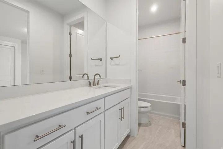 Bathroom featuring vanity and shower / bath combination