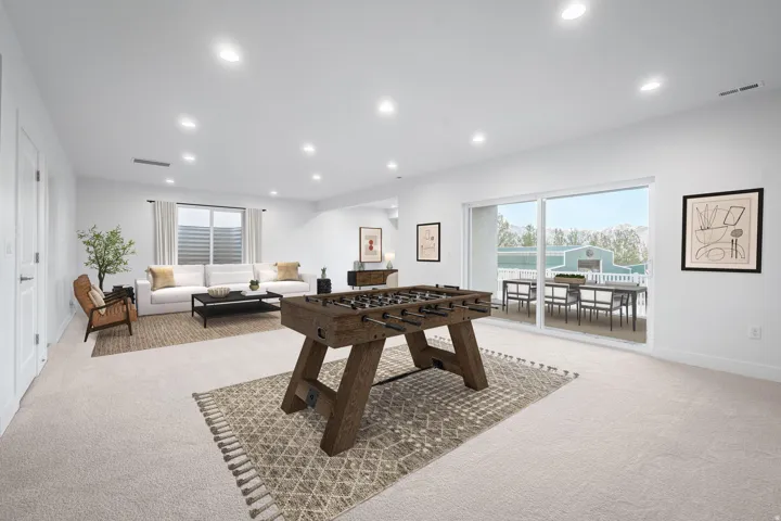 Spacious recreation room featuring recessed lighting and light-toned carpeting