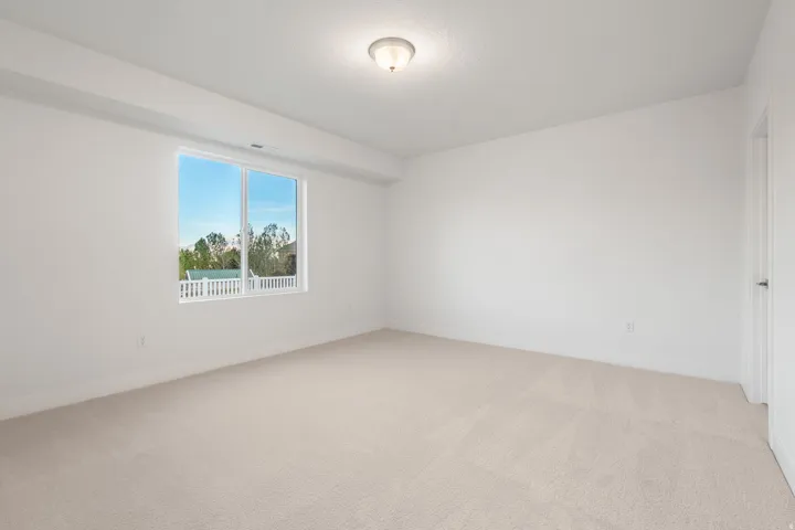 Unfurnished room with light carpet and baseboards
