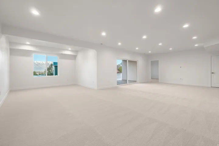 Spare room with light carpet, recessed lighting, and plenty of natural light