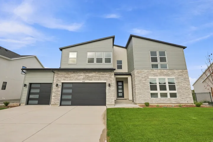 Modern architectural design featuring varied siding, stone accents, and multiple large windows