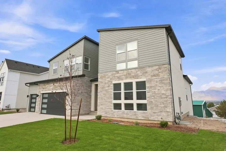 Modern exterior architecture featuring a multi-tone facade, stone veneer, and horizontal siding