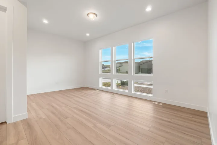 Spare room with light wood-type flooring and recessed lighting