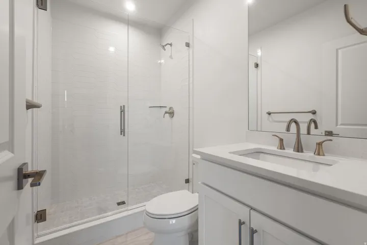 Full bath with vanity and a shower stall