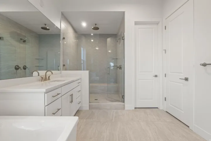 Full bathroom featuring vanity, a stall shower, and a closet