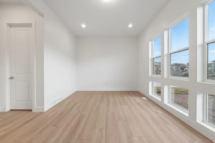 Unfurnished room featuring light wood-style floors, recessed lighting, and plenty of natural light