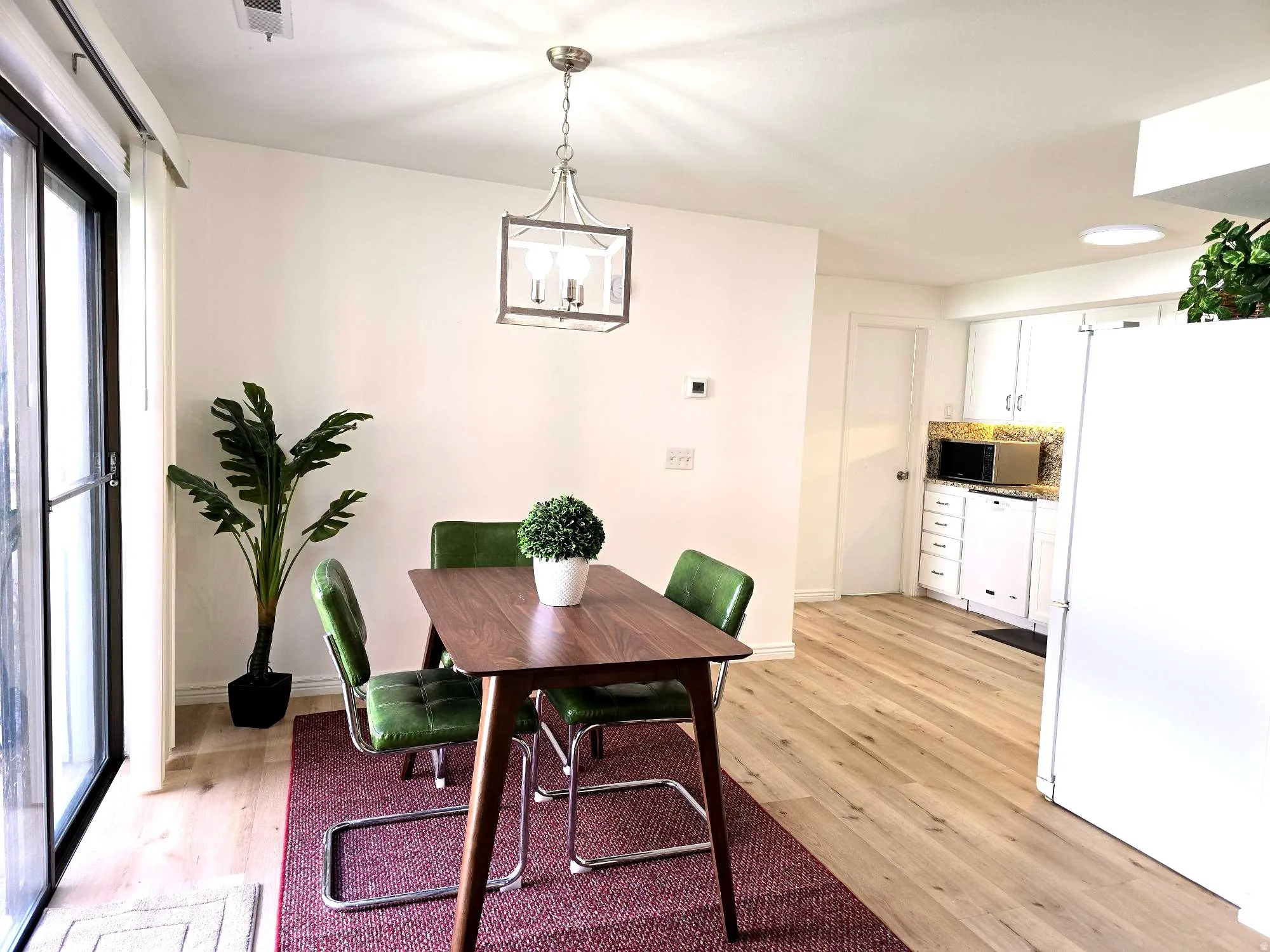 Dining room featuring light wood-style floors and hanging lights