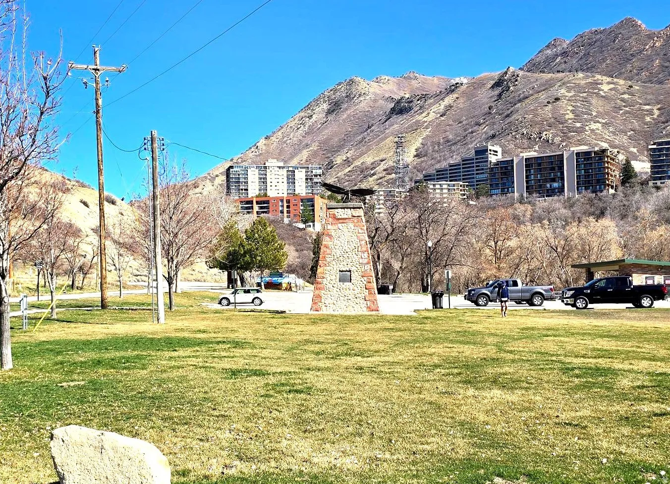 View of subject building (red brick) from Emigration Canyon Park.the