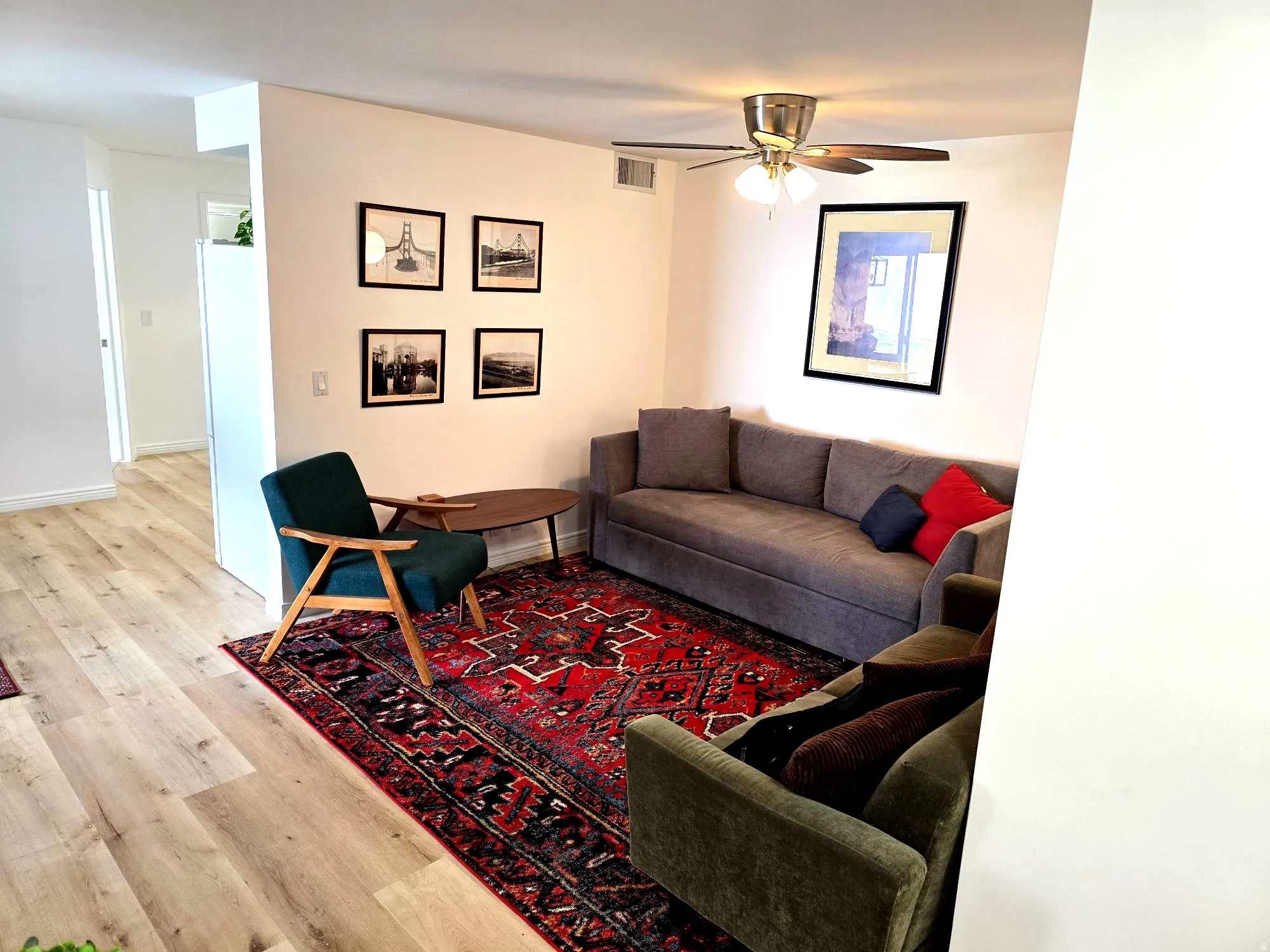 Living room featuring light wood-type flooring and ceiling fan