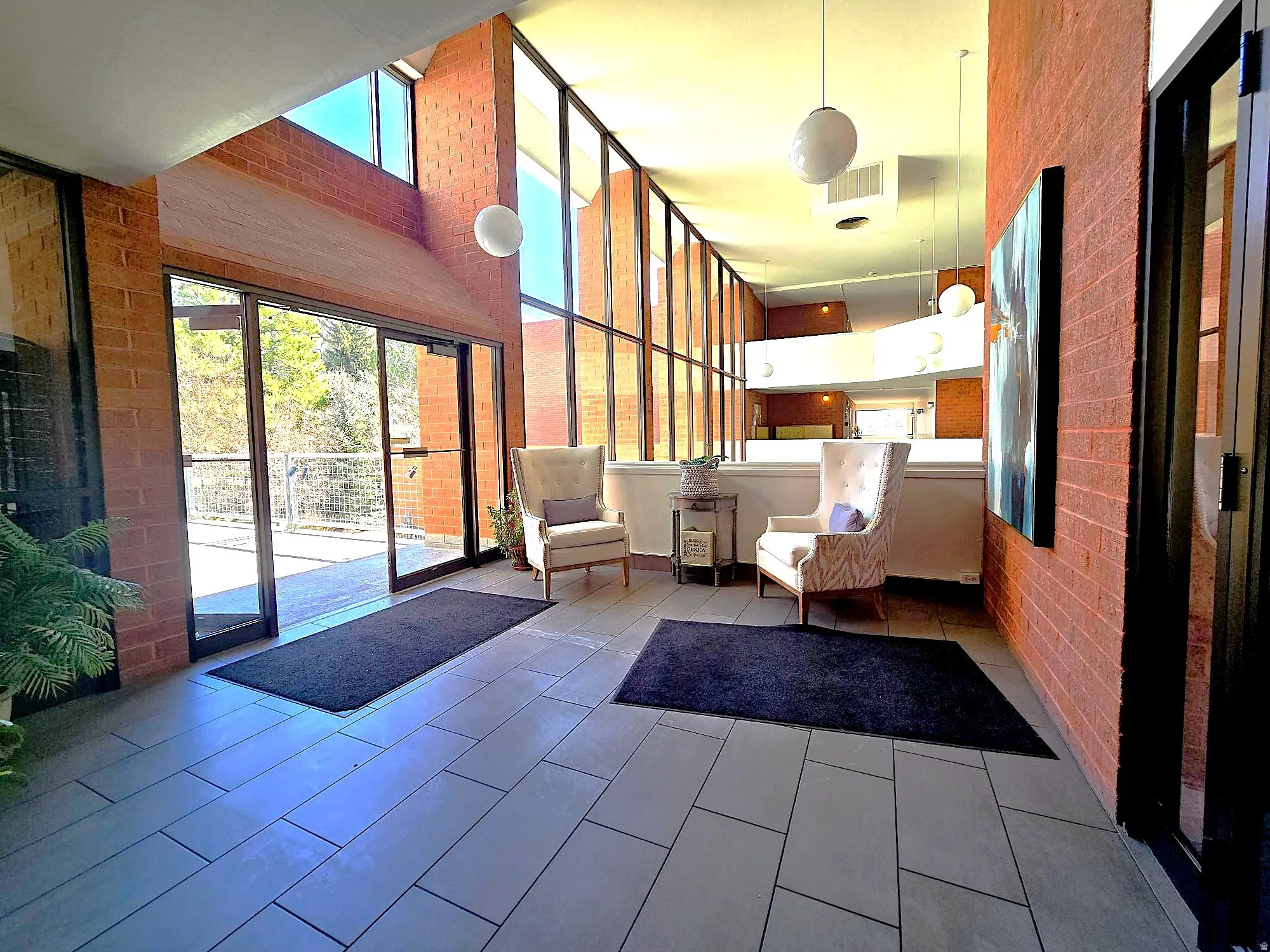 Community lobby with brick wall and a high ceiling