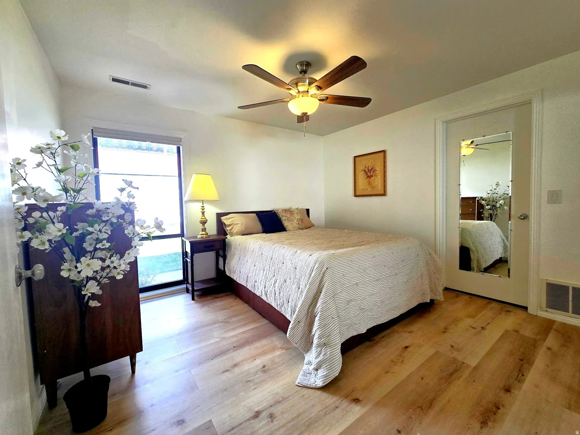 Bedroom featuring light wood-style flooring and a ceiling fan