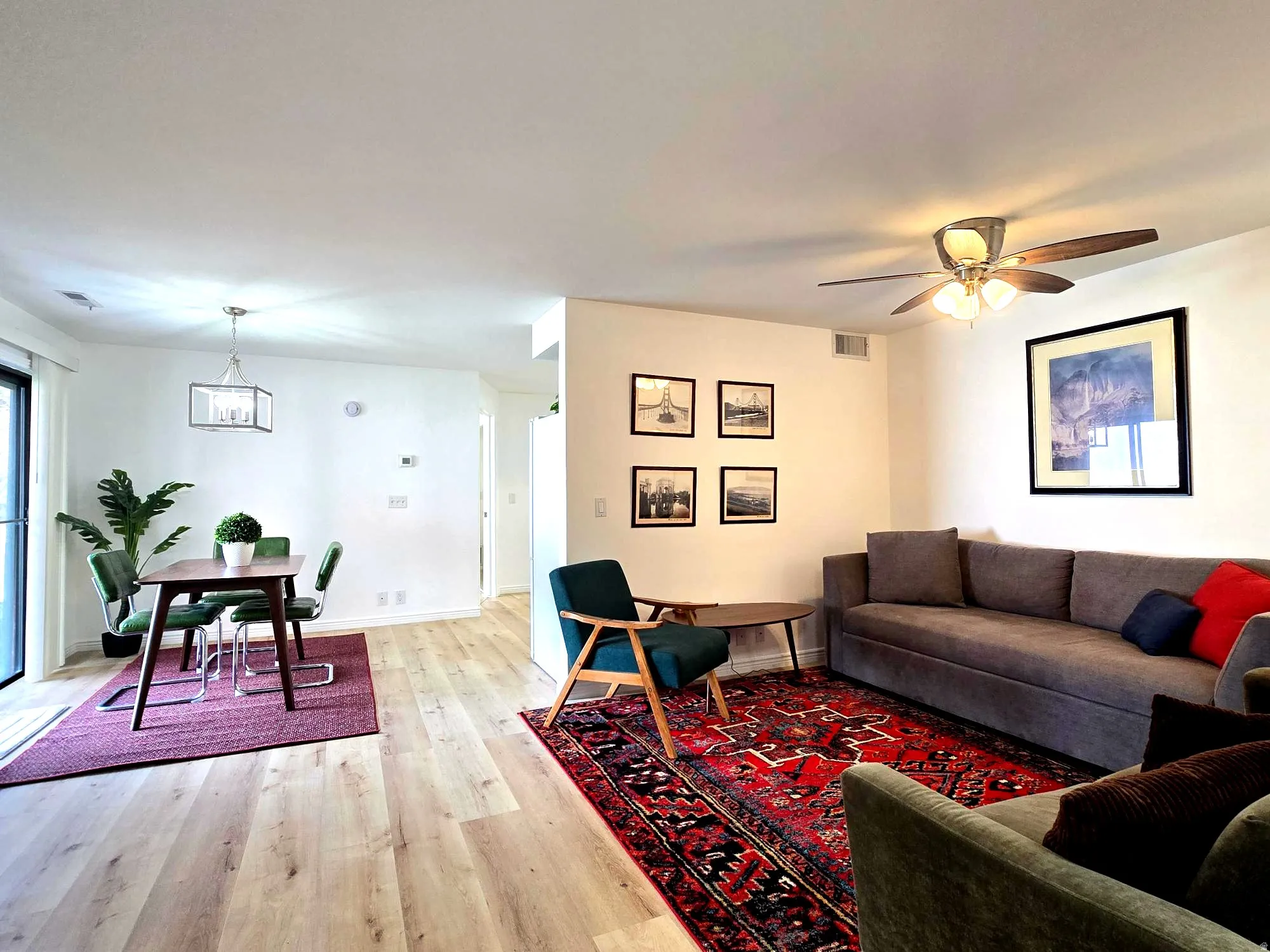 Living area with light wood-style flooring and ceiling fan