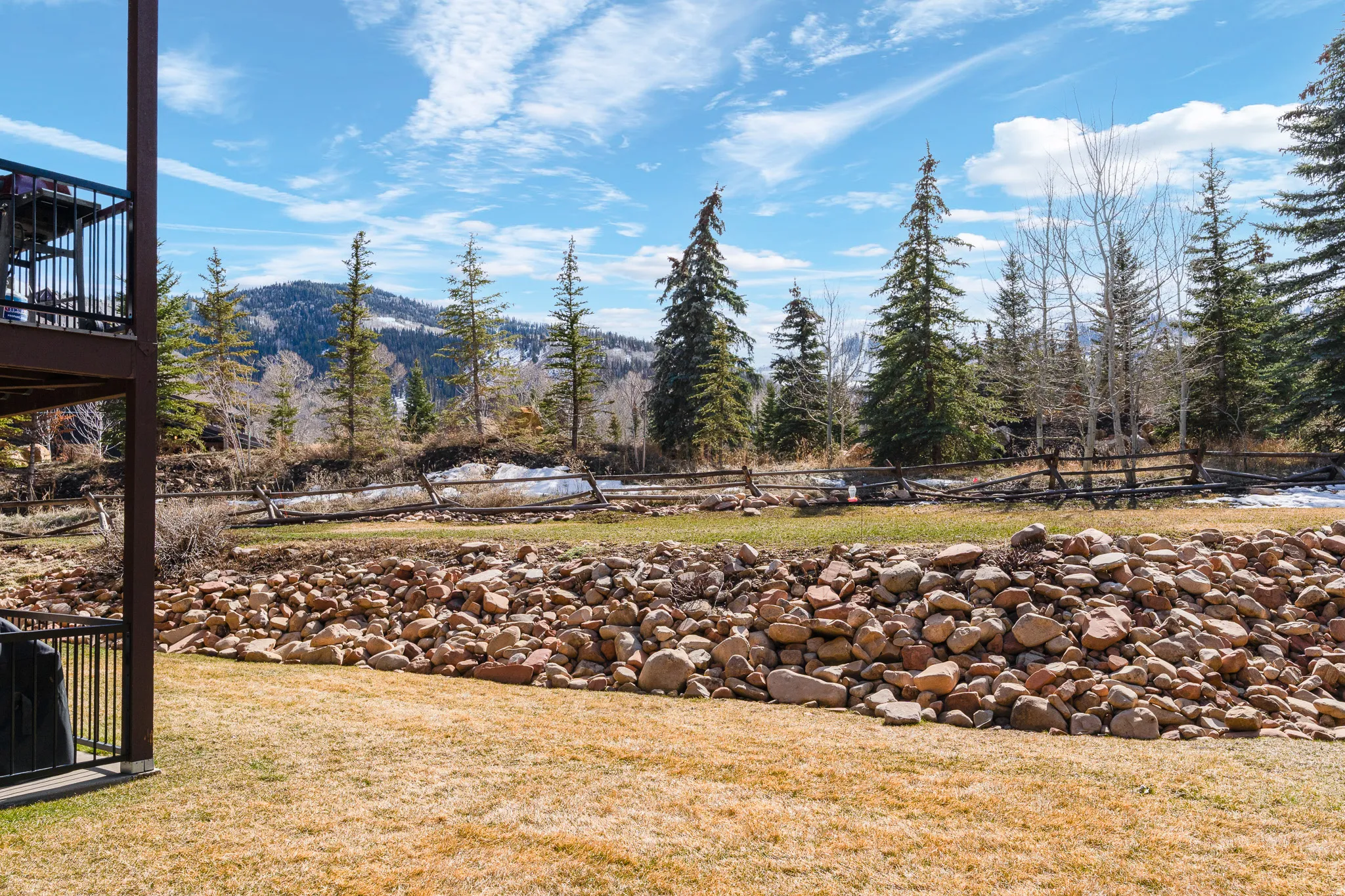 View of green lawn featuring a mountain view
