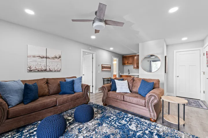 Living area with light wood finished floors, ceiling fan, and recessed lighting