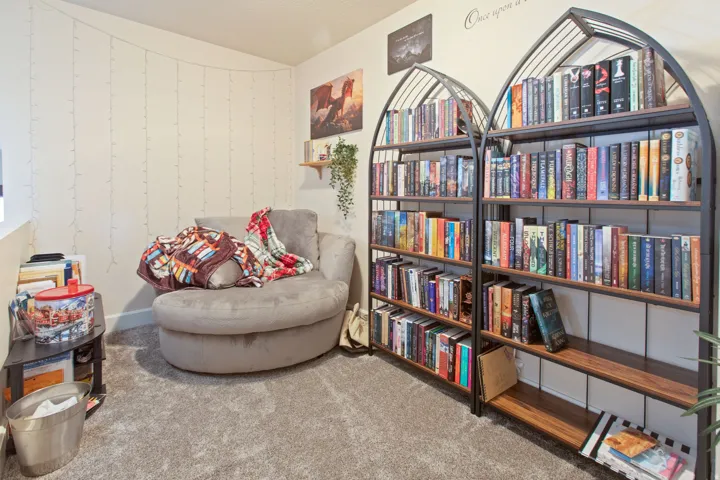 Sitting room with light carpet and lofted ceiling